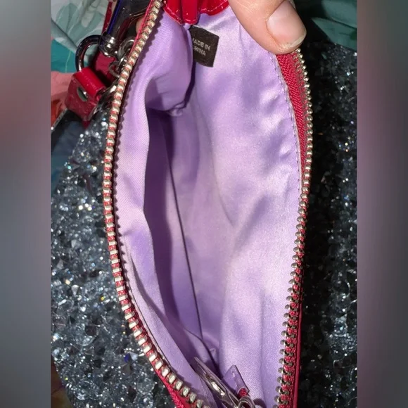 Coach Poppy Wristlet featuring a pink and purple geometric pattern. - Picture 6 of 9